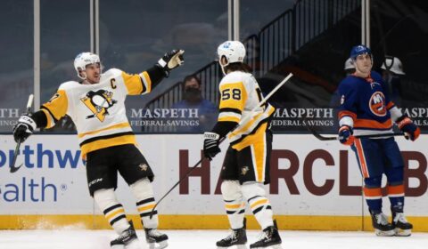 Sidney Crosby #87 greets teammate Kris Letang #58 of the Pittsburgh Penguins who scored the game-winning OT goal against the New York Islanders.