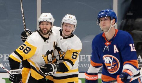 Kris Letang #58 of the Pittsburgh Penguins celebrates his second period goal against the New York Islanders with teammate Jake Guentzel #59.