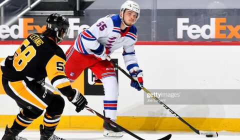 PITTSBURGH, PA - MARCH 07: Ryan Lindgren #55 of the New York Rangers handles the puck against Kris Letang #58 of the Pittsburgh Penguins at PPG PAINTS Arena on March 7, 2021 in Pittsburgh, Pennsylvania. 