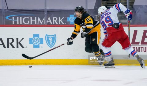PITTSBURGH, PA - MARCH 07: Pittsburgh Penguins Defenseman Kris Letang (58) skates with the puck while New York Rangers Right Wing Pavel Buchnevich (89) defends during the second period in the NHL game between the Pittsburgh Penguins and the New York Rangers on March 7, 2021, at PPG Paints Arena in Pittsburgh, PA. 